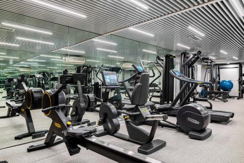 a gym with a lot of treadmills and machines at Helvetia Hotel in Saint Petersburg