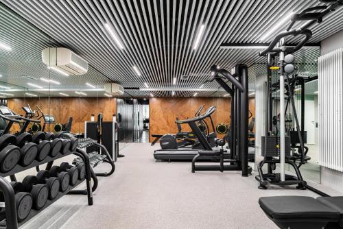 einen Fitnessraum mit Laufbändern und Crosstrainern in der Unterkunft Helvetia Hotel in Sankt Petersburg