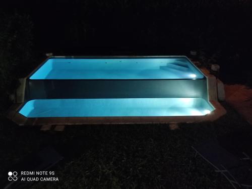 a blue bench sitting in the grass at night at Chalet Aurore in Mérignac