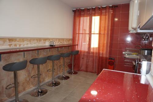 a kitchen with a counter and bar stools at Mucho Madrid in Madrid