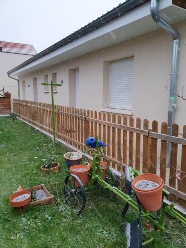 a bike parked in a yard next to a fence at Appartement d'une chambre avec vue sur la ville jardin clos et wifi a Dijon in Dijon