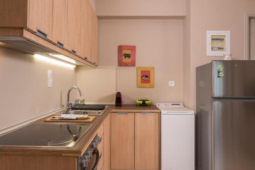 a kitchen with a sink and a refrigerator at Tholos Apartments in Chania Town