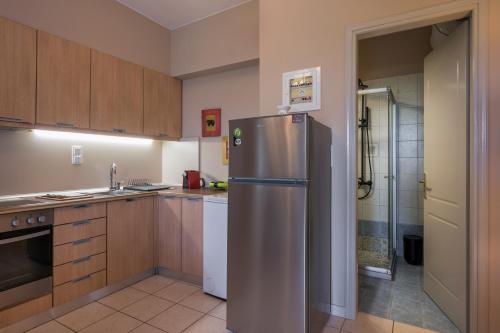 a kitchen with a stainless steel refrigerator in it at Tholos Apartments in Chania Town