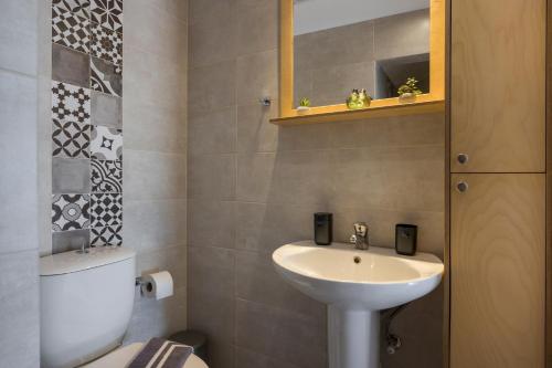 a bathroom with a sink and a toilet at Tholos Apartments in Chania Town