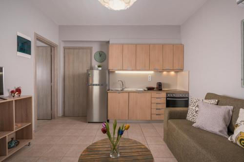 a kitchen and living room with a couch and a table at Tholos Apartments in Chania Town