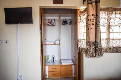a living room with a television and a window at Furnishedapartments in Nairobi