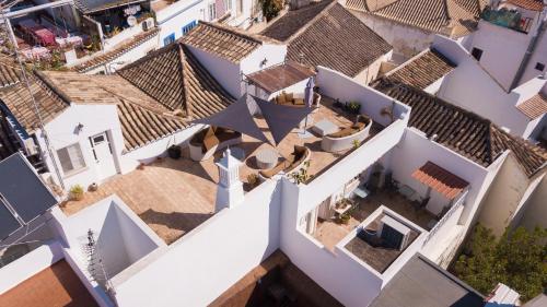 an overhead view of roofs of white buildings at Enchanted Villa in Tavira
