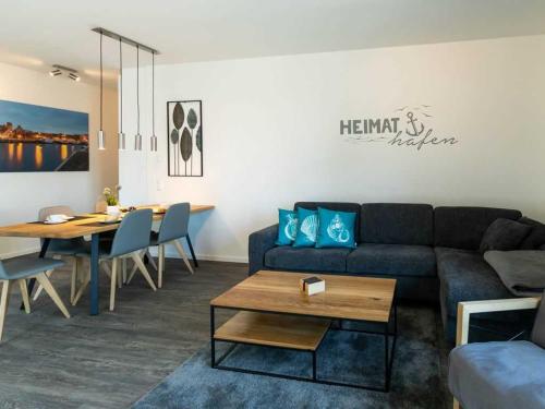 a living room with a couch and a table at Hafenspitze App 36 in Wismar