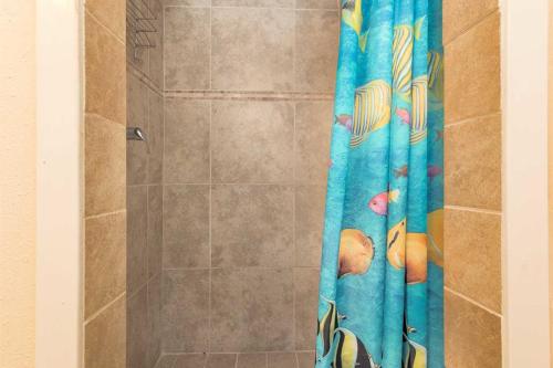 a shower with a blue shower curtain in a bathroom at Ft Morgan Town Homes in Gulf Shores