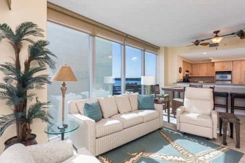 a living room with a couch and chairs and a kitchen at Island Tower in Gulf Shores