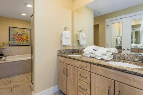 a bathroom with two sinks and a bath tub at Island Tower in Gulf Shores