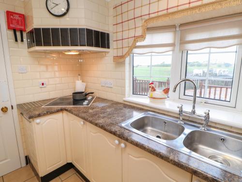 a kitchen with a sink and a window at The Chalet in Northallerton