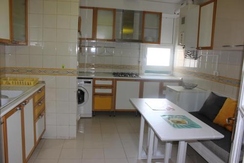 a small kitchen with a table and a counter top at Appartement Alain savary in Tunis