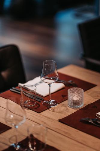 a table with two wine glasses and a napkin at The HEY HOTEL in Interlaken