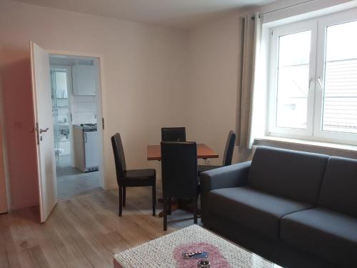 a living room with a couch and a table at Gasthof zur Alten Post in Wimmelburg