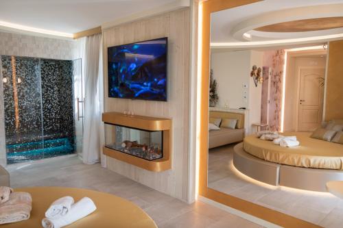 a hotel room with a fireplace and a bedroom at Il Giardino degli Angeli in Rivotorto 