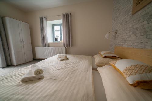 a bedroom with two beds with towels on them at Stará Celnice Kvilda in Kvilda