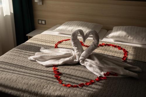 a heart made out of towels on a bed at Kristály Hotel in Keszthely