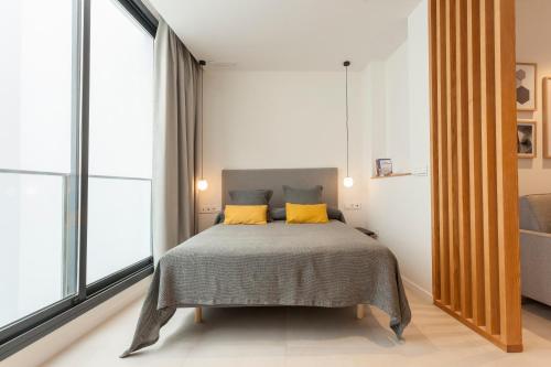 a bedroom with a bed and a dresser at Apartamentos Málaga Premium - Calle Granada in Málaga