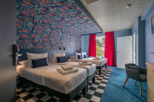 a bedroom with two beds and a large painting on the wall at ibis Styles Dijon Sud Domaine De Beauregard 21600 Longvic in Longvic