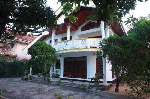 a house with a balcony on the side of it at Airport Residence Inn in Katunayake