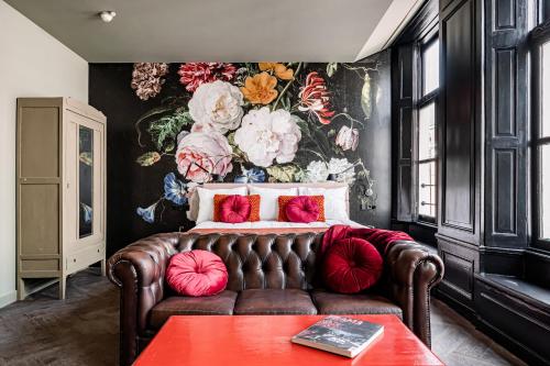 a bedroom with a couch and a flower wall at MAF Haarlem Boutique Hotel in Haarlem