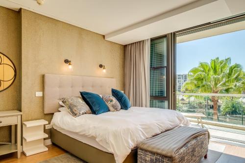 a bedroom with a bed and a large window at 308 Juliette in Cape Town