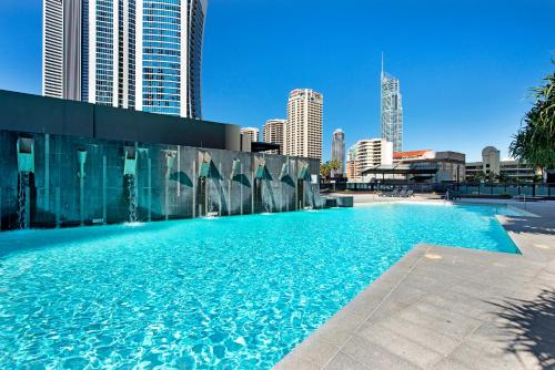 a large swimming pool in a city with tall buildings at Circle On Cavill Surfers Paradise Apartments-Holiday Paradise in Gold Coast