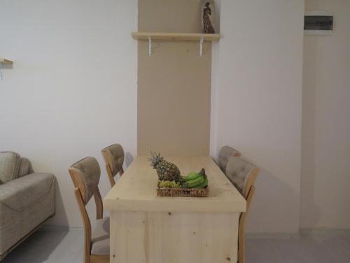 a table with a pineapple and bananas on it at Santa Suites- Near Saint Nicholas Church in Demre