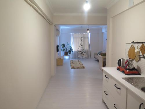 a kitchen with white walls and a white floor at Santa Suites- Near Saint Nicholas Church in Demre