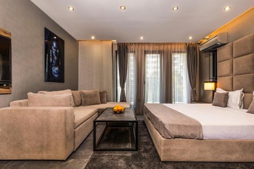 a hotel room with a bed and a couch at SOHO Apart House in Plovdiv
