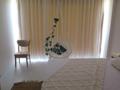 a bedroom with a swing and a chair at Santa Suites- Near Saint Nicholas Church in Demre