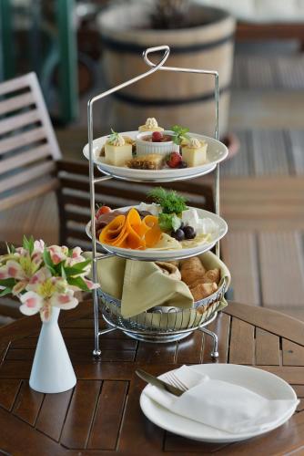 a three tiered tray of food on a table at Grand Hotel Sofia in Sofia