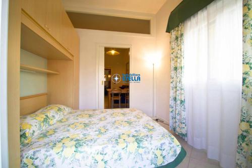 1 Schlafzimmer mit einem Bett mit Blumenbettdecke in der Unterkunft Condominio Hawaii in Lido di Jesolo