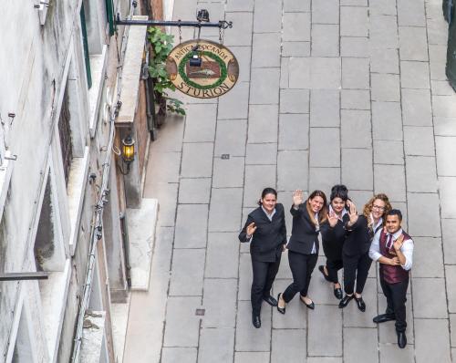 a group of people standing on a street at Antica Locanda Sturion Residenza d'Epoca in Venice
