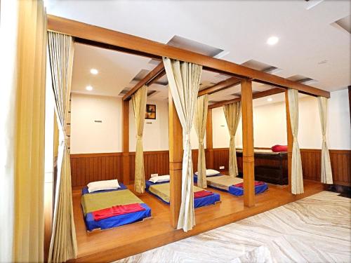 a room with four beds in it at Indira Nikunj Rubystone Exotic in Rishīkesh