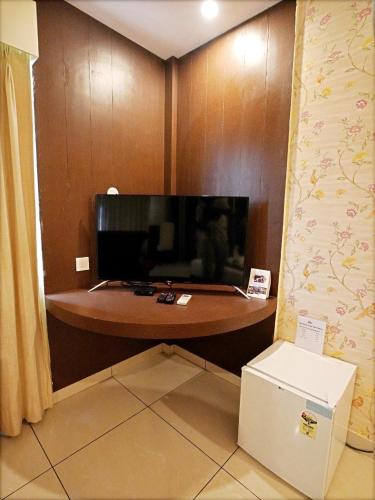 a table in a room with a tv and a box at Indira Nikunj Rubystone Exotic in Rishīkesh