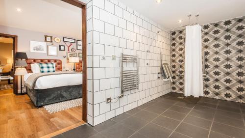 a hotel room with a bed and a shower at Hotel Indigo York by IHG in York
