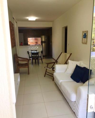 a living room with a white couch and a table at Charming Guarajuba in Guarajuba