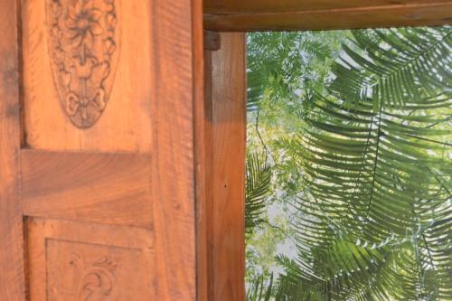 a close up of a wooden door with a window at Tsartsada house in Áno Lefkímmi