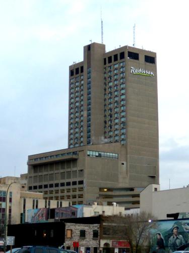 a tall building with a rolex sign on it at Radisson Hotel Winnipeg Downtown in Winnipeg