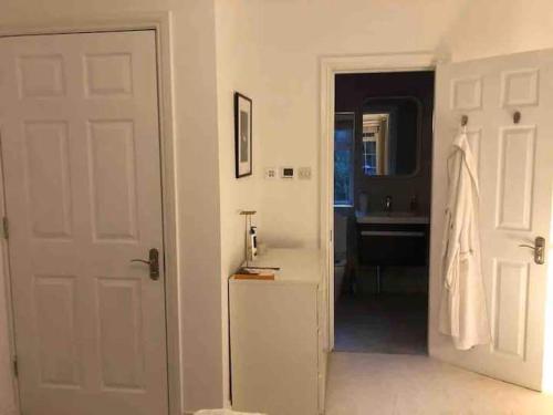 a white door leading to a bathroom with a sink at Chartleigh in Southampton