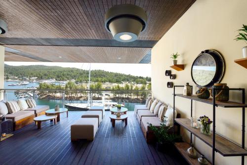a living room filled with furniture and a balcony at Porto Carras Meliton in Neos Marmaras
