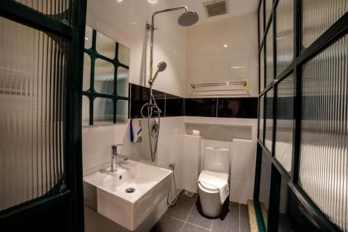 a small bathroom with a sink and a toilet at Eastern Hotel Georgetown in George Town