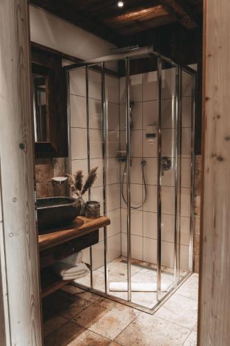a bathroom with a shower and a sink at Jufenalm BOHO & Wellnesshotel in Maria Alm am Steinernen Meer