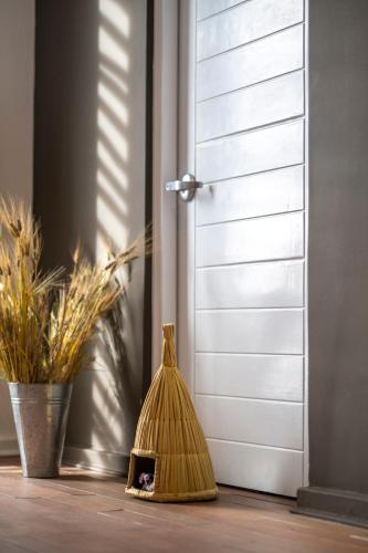 a broom sitting on a floor next to a door at Titilaka by Andean in Tililaca