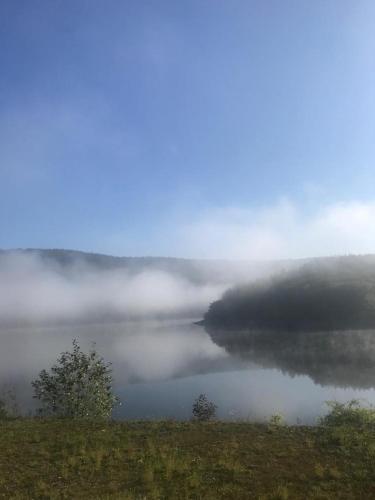 a view of a lake with clouds in the water at Apartment Deluxe, inklusive WLAN, Parkplatz und Netflix in Schleiden