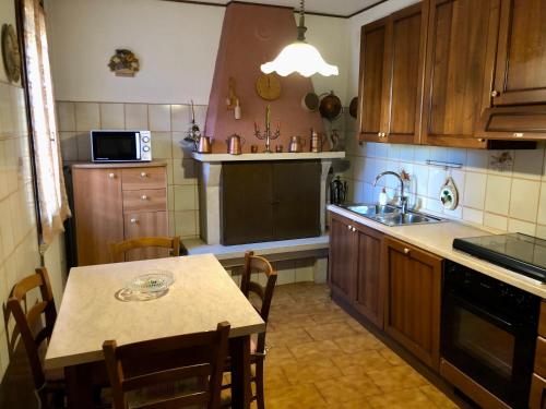 a kitchen with a table and a kitchen with a sink at La Casa in Cerea
