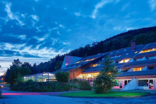 a building with lights on in front of it at Village Vacances Le Mongade (by Popinns) in Plainfaing