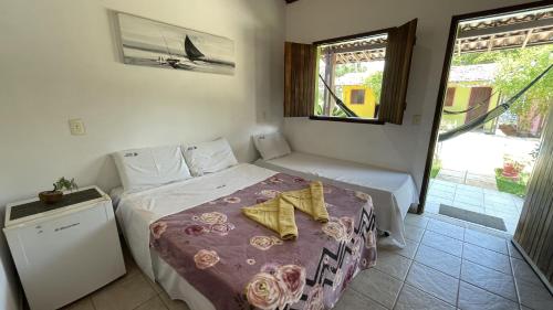 En eller flere senge i et værelse på Pousada Caravelas